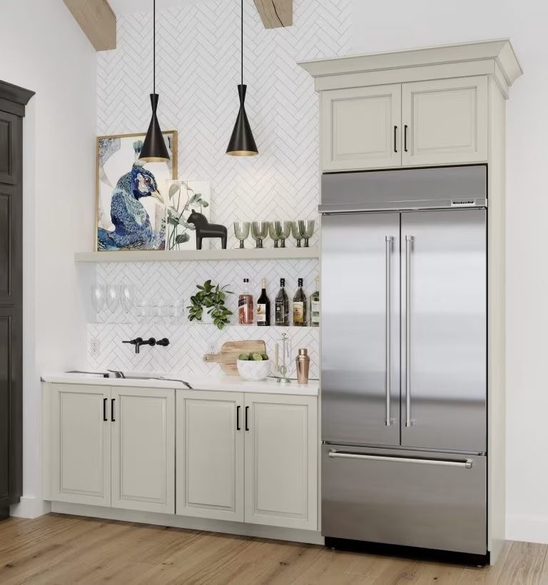 Modern white kitchen with stainless steel fridge, cabinets, pendant lights, and countertop decor