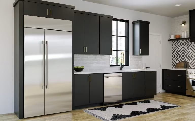 Modern kitchen with black cabinets, stainless steel fridge, window, and patterned backsplash