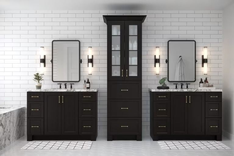Modern bathroom with black double vanities and a tall center cabinet against a white brick wall.