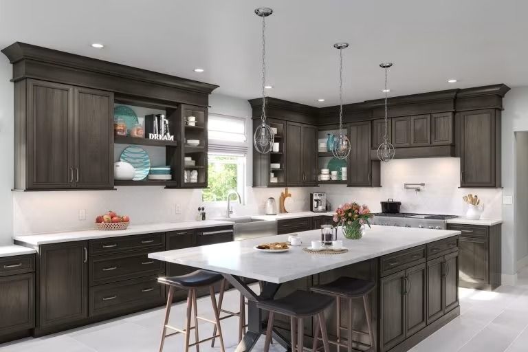 Modern dark wood kitchen with large island, white countertops, pendant lights, and stainless appliances