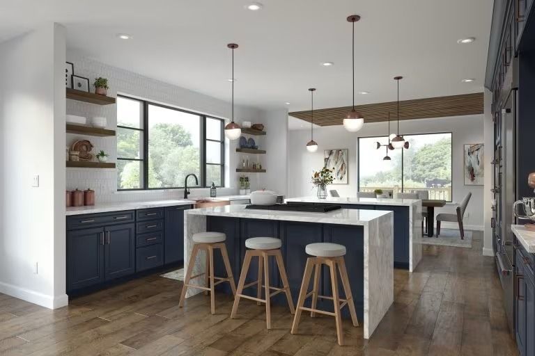 Modern kitchen with navy cabinets, white island, bar stools, pendant lights, and large windows