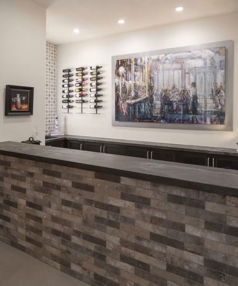 Modern reception desk with stone front, wall art, and eyeglasses display in a softly lit interior
