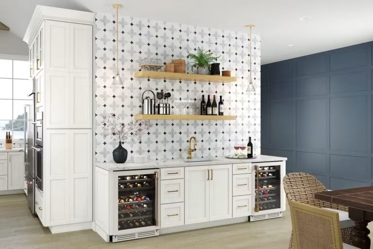 Modern kitchen bar with white cabinets, blue tiled wall, open shelves, and wine fridges
