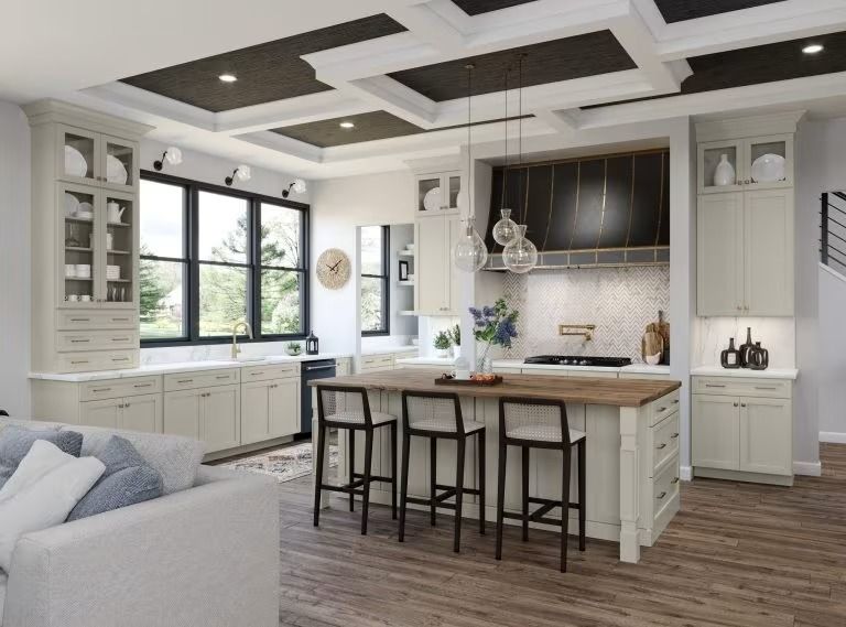 Bright modern kitchen with white cabinets, island seating, large window, and gray accents