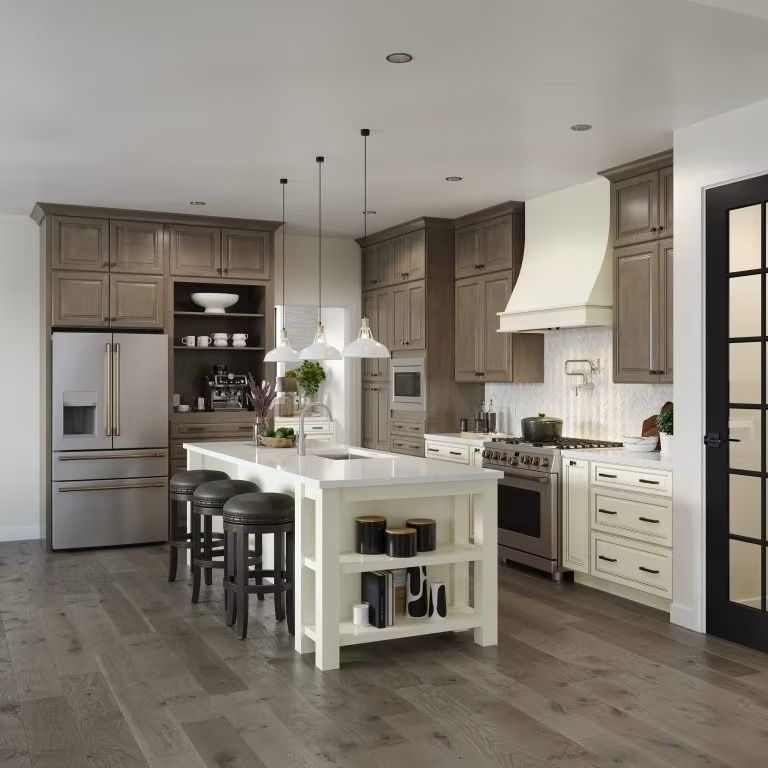 Modern kitchen with brown cabinets, white island, stainless appliances, and dark wood floors