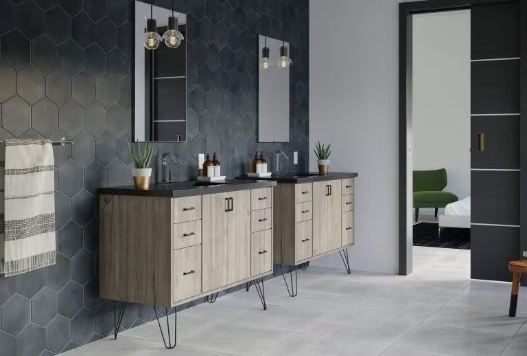Modern bathroom vanity with double mirrors, dark wall tiles, and a doorway to another room