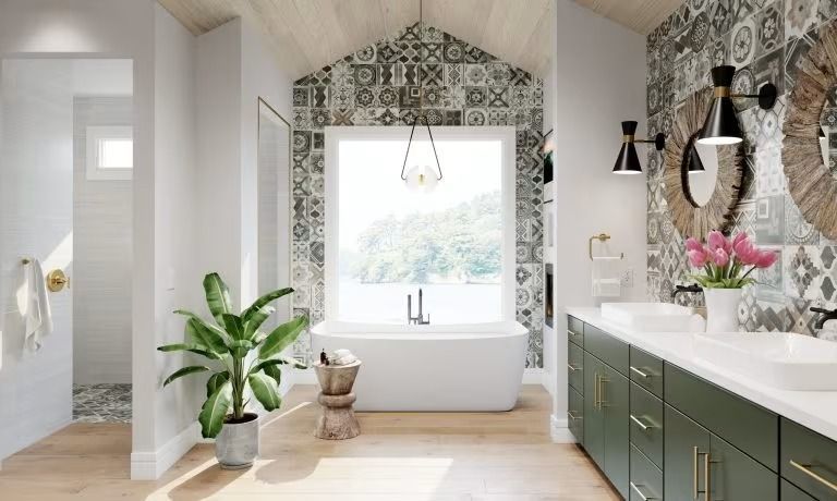 Bright bathroom with patterned wallpaper, freestanding tub, vanity, and potted plant by a large window