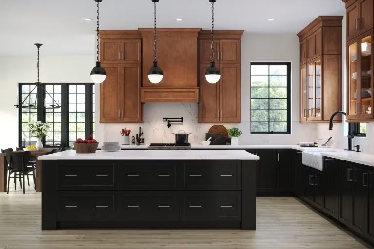 Modern kitchen with black island, white countertops, wood cabinets, and pendant lights
