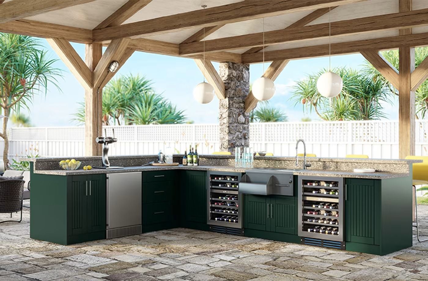 Outdoor kitchen with green cabinets, grill, sink, and stone countertop under a wooden pavilion