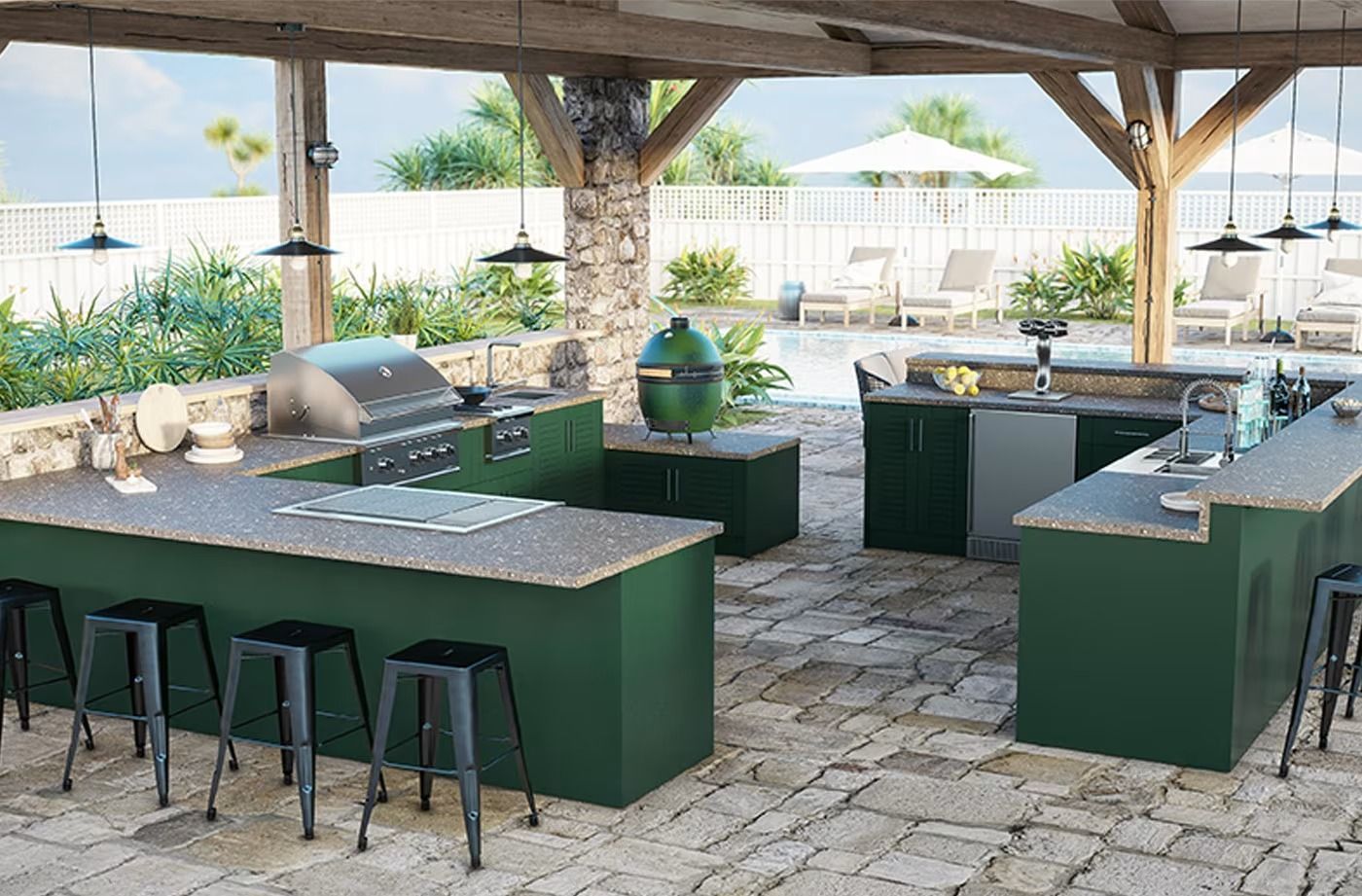 Outdoor kitchen with green counters, bar stools, and grill under a wooden pavilion