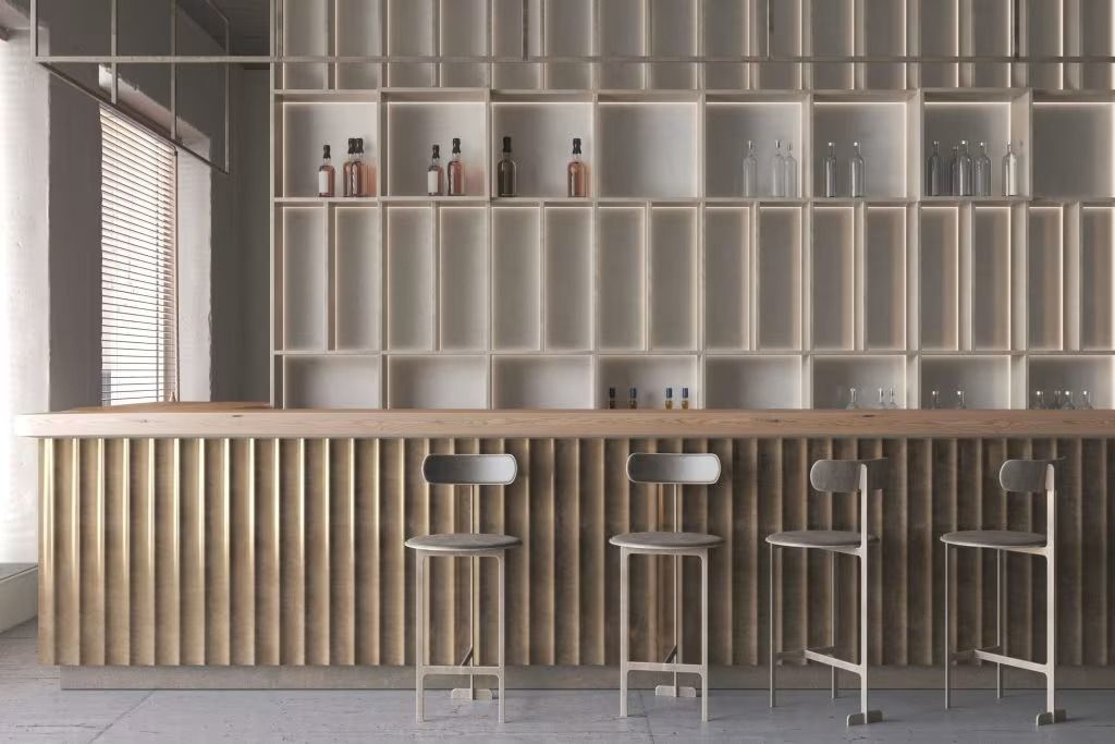 Modern bar interior with wood slat counter, shelves, and four stools against a tiled wall