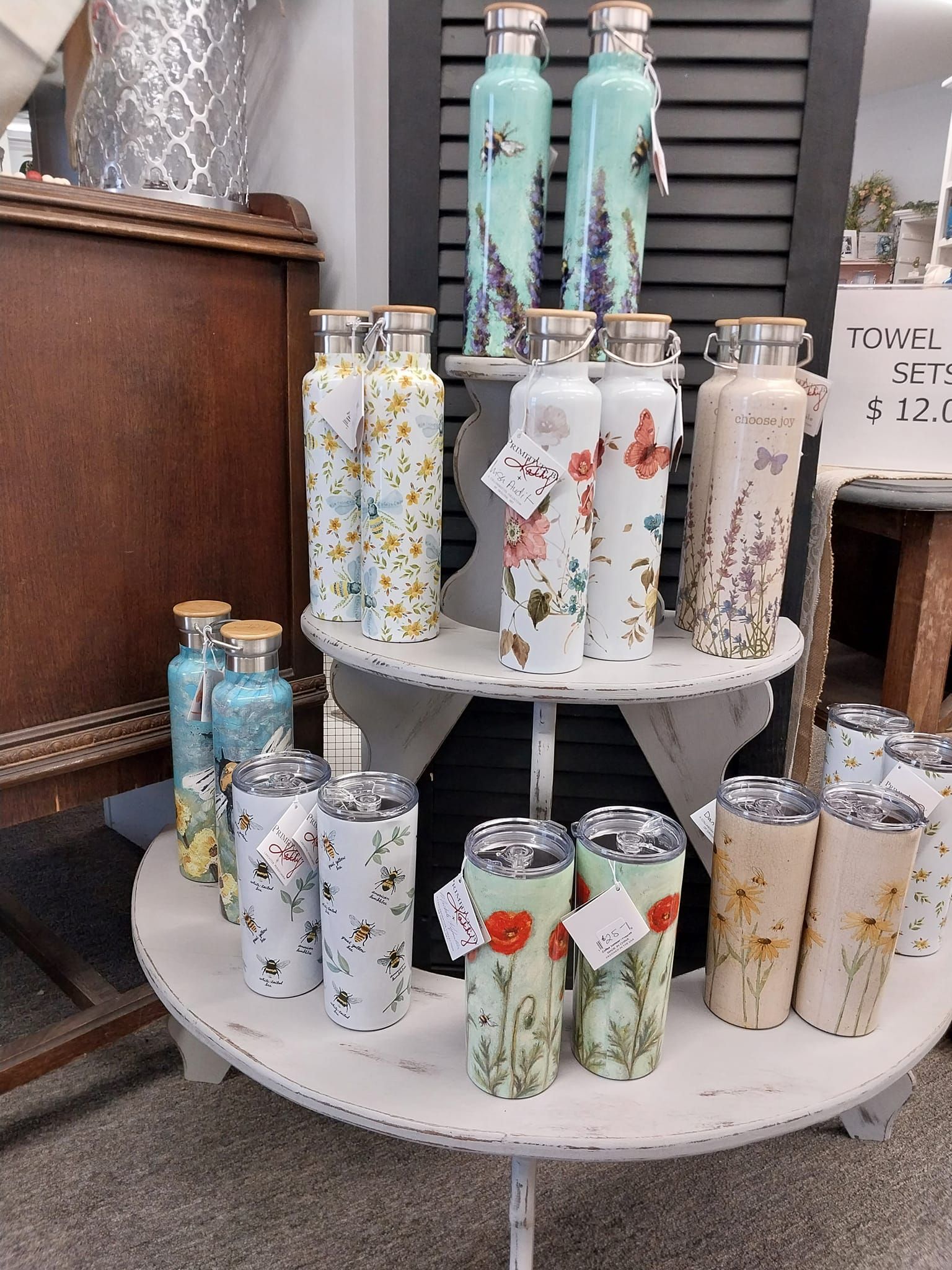 A display of water bottles and tumblers on a table.