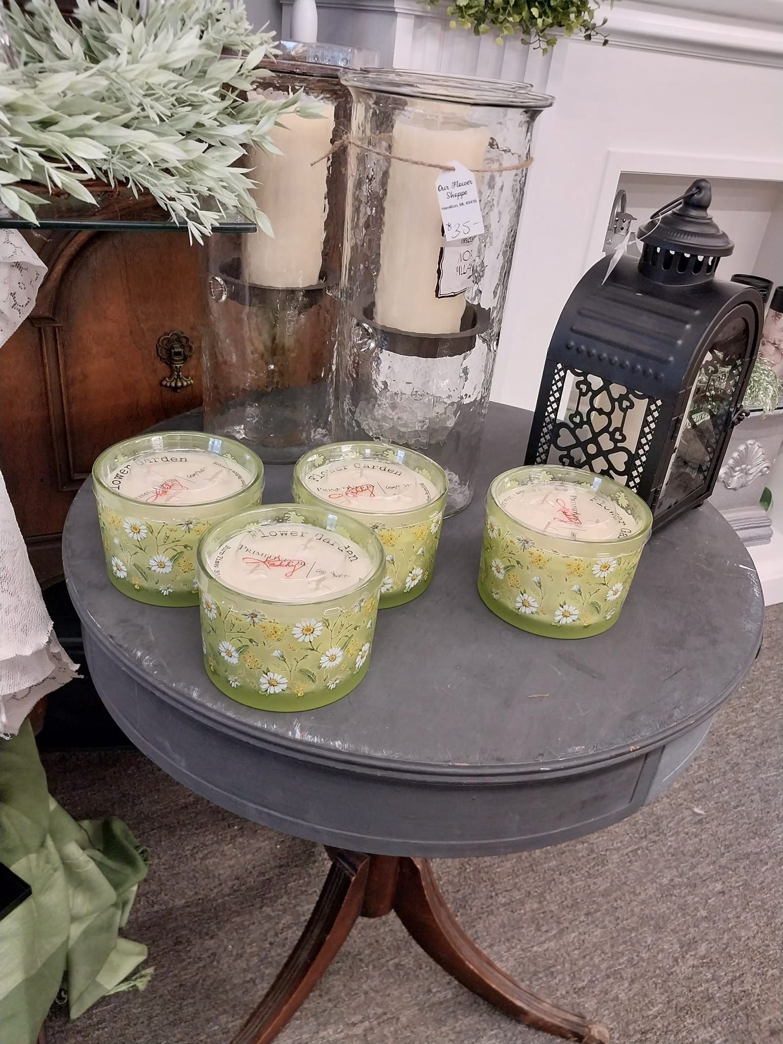 A table with candles and a lantern on it.