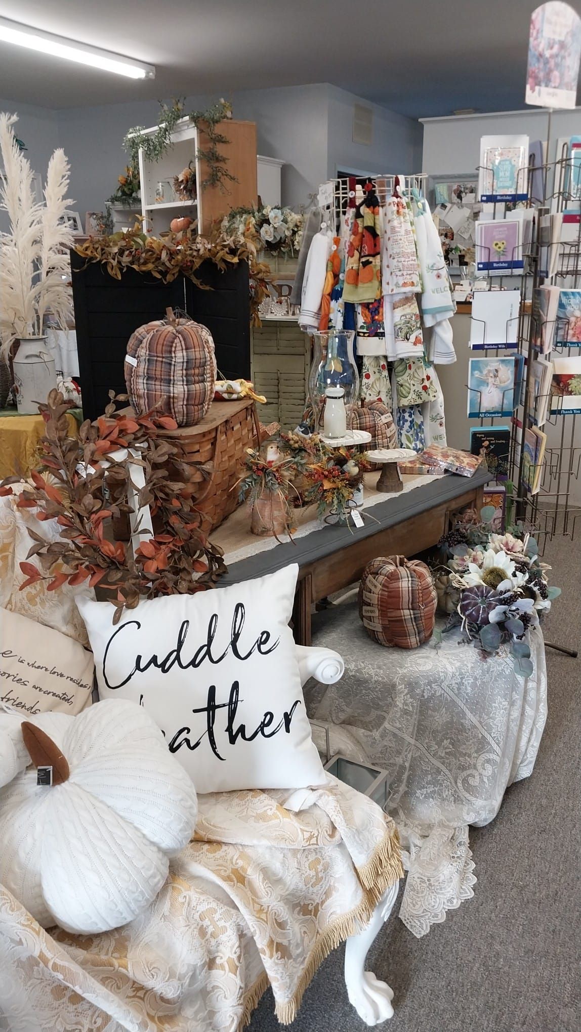 A store filled with lots of decorations and a pillow that says `` cuddle each other ''.