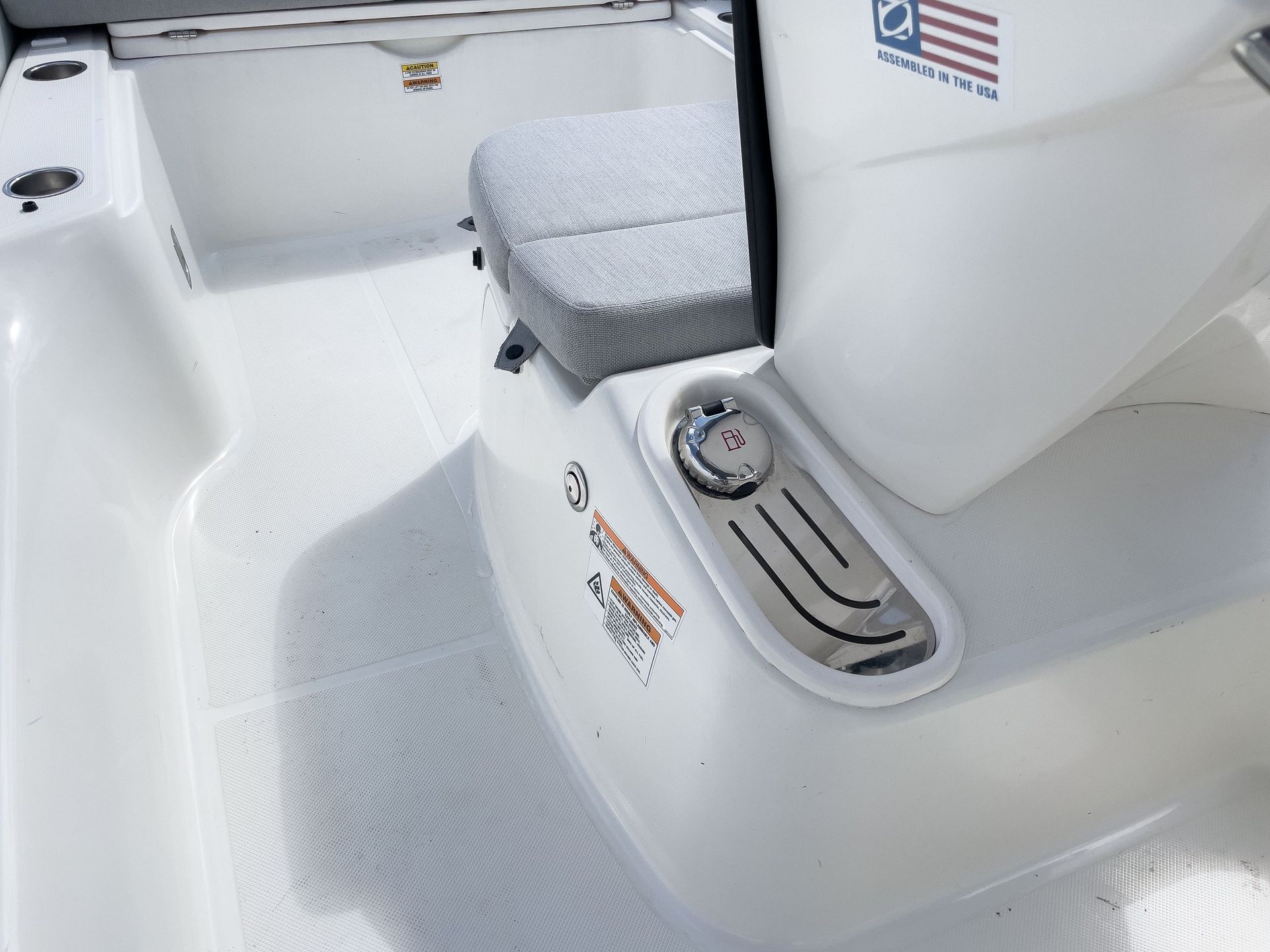 A white boat with an american flag on the side of it