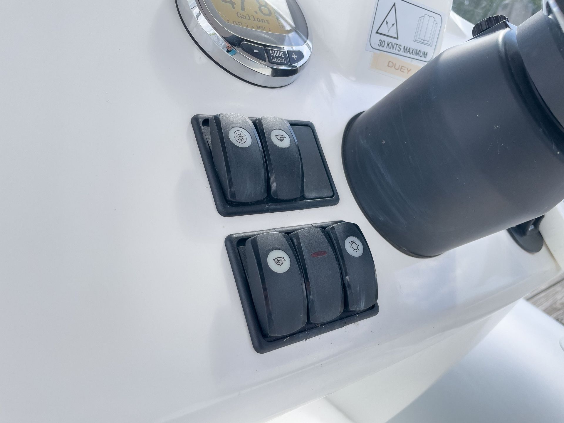 A close up of two electrical switches on a boat