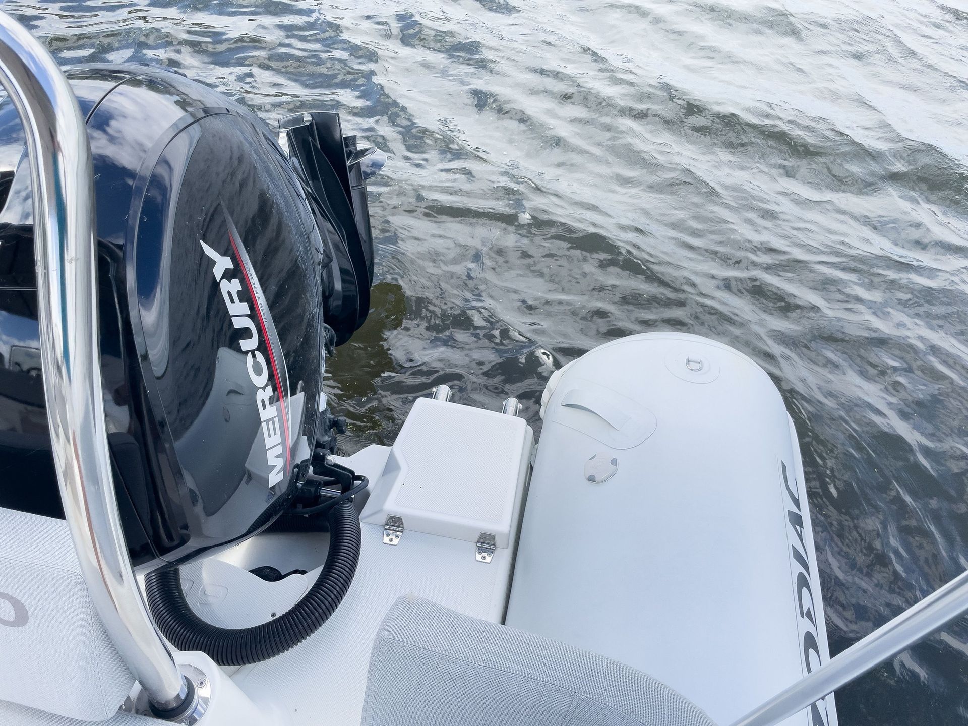A mercury outboard motor is sitting on the side of a boat