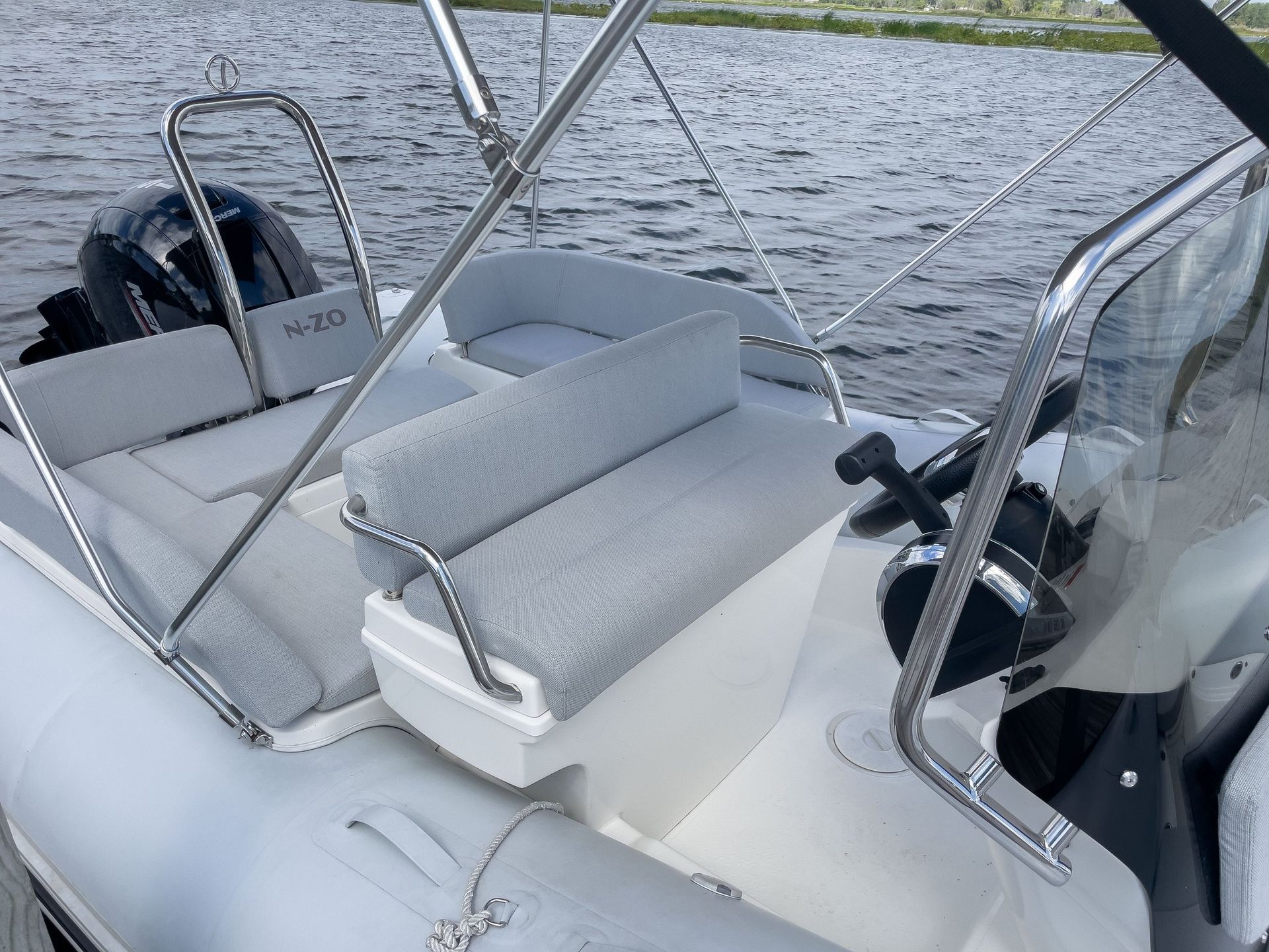 A white boat is floating on top of a body of water.
