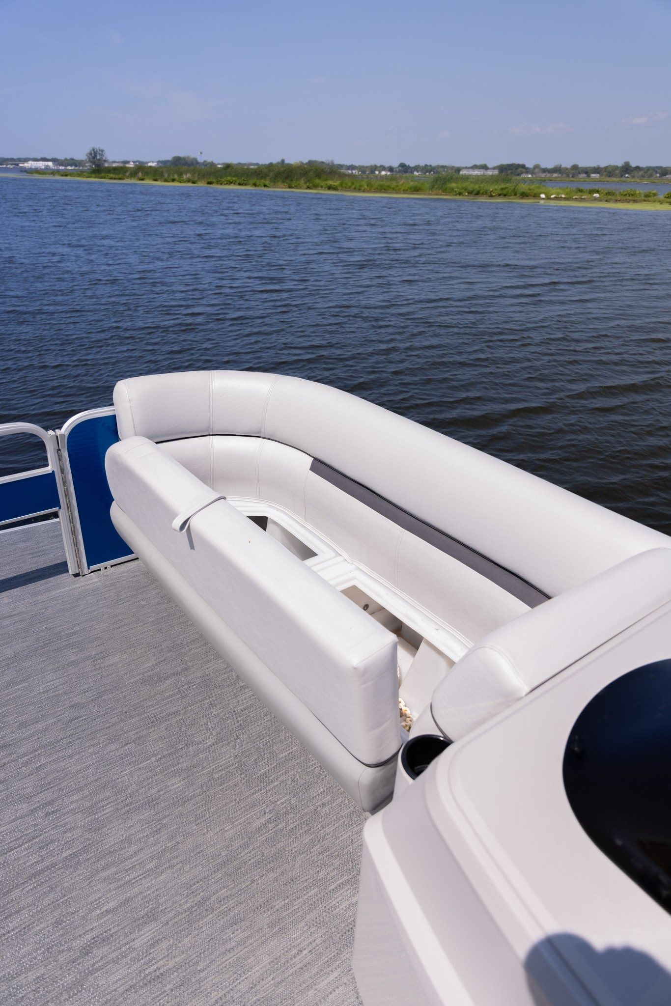 A pontoon boat is floating on top of a body of water.