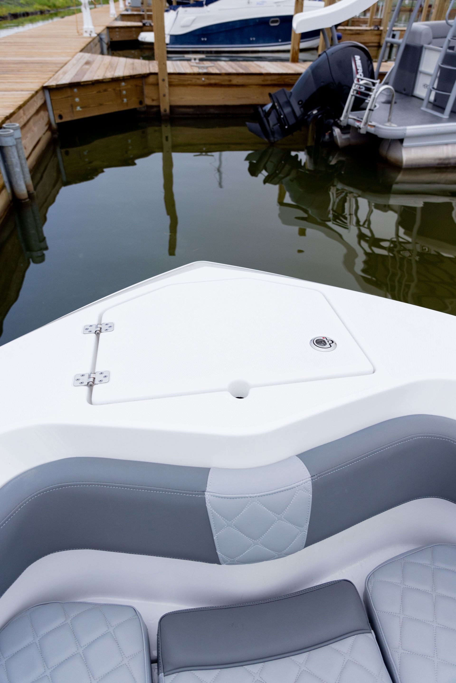 A boat is docked at a dock next to a body of water.