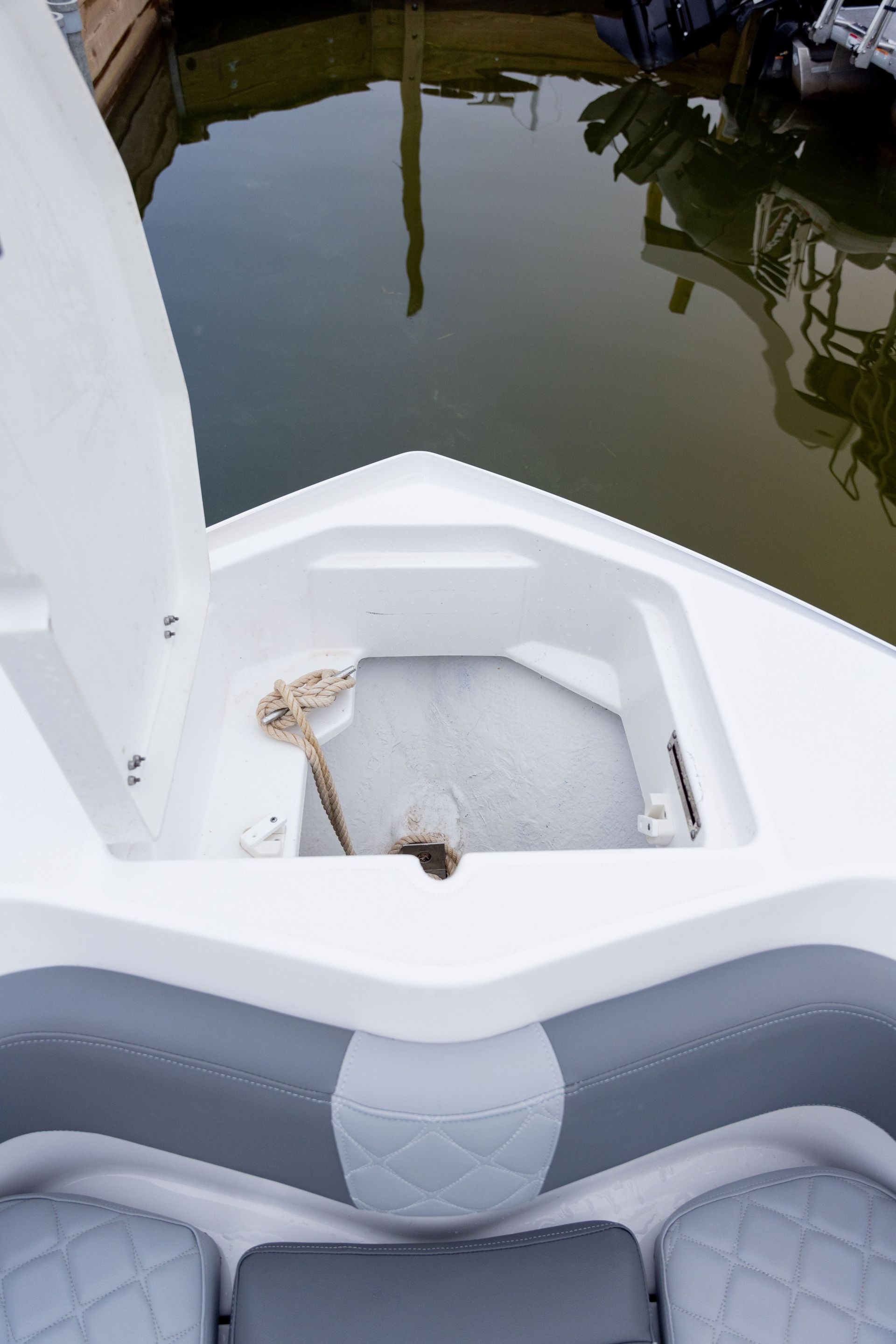 The back of a boat with the door open and a rope in it.