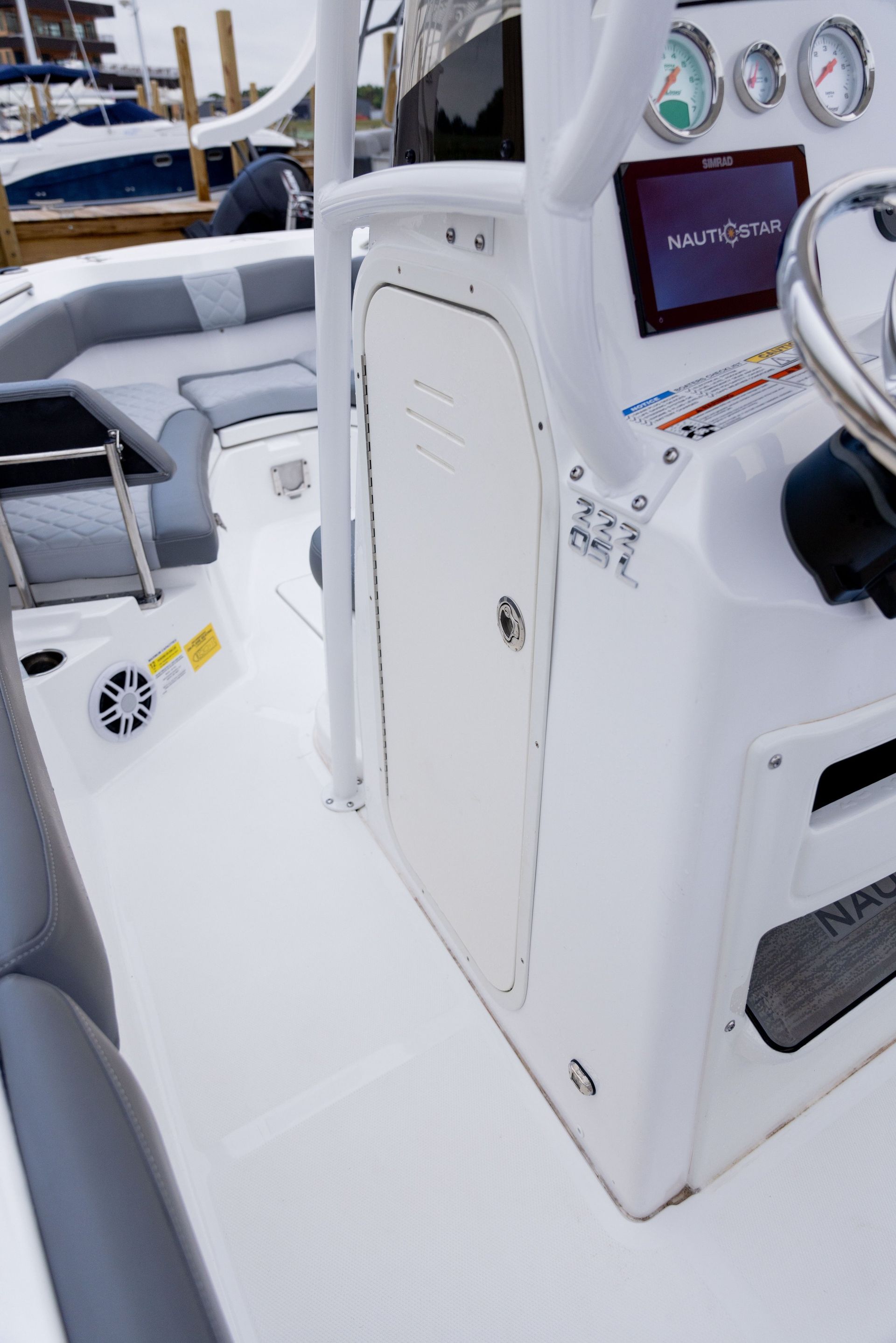 A white boat with a steering wheel and a steering wheel.