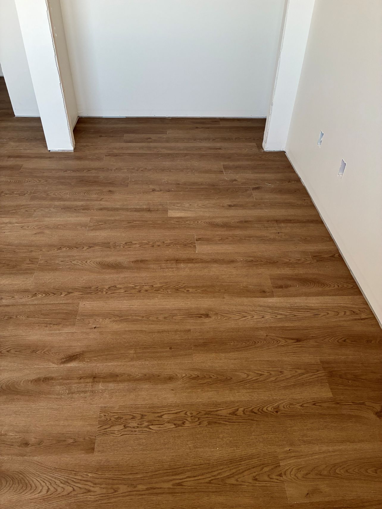 Empty room with wood-look flooring and white walls