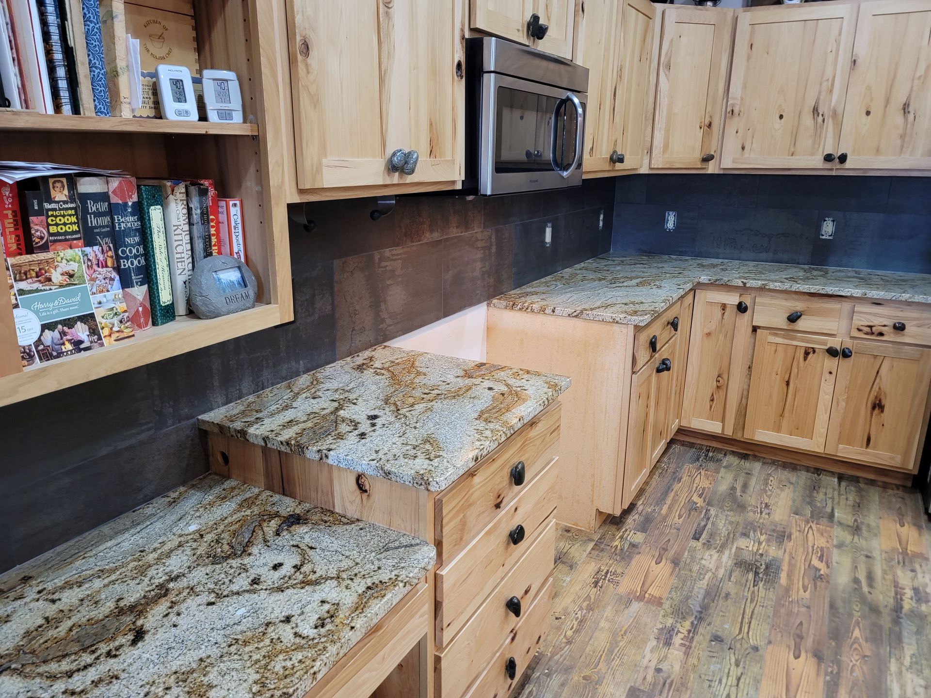 Rustic kitchen with wood cabinets, granite countertops, and a corner sink by a window
