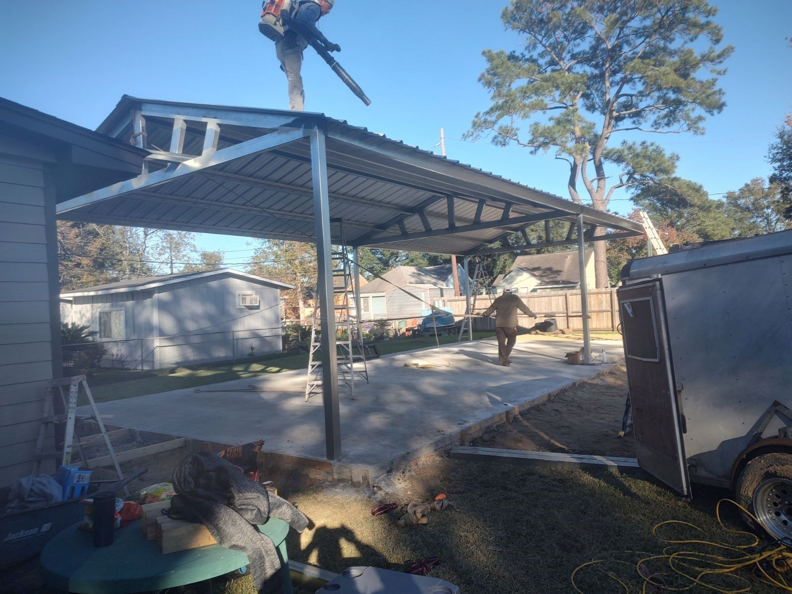 A man is standing on top of a metal structure.