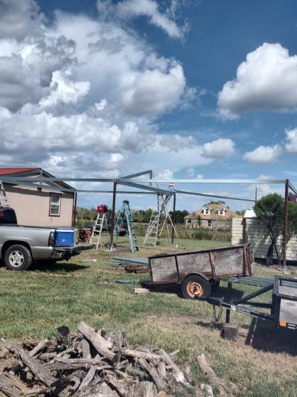 A truck is parked in a grassy field next to a trailer.