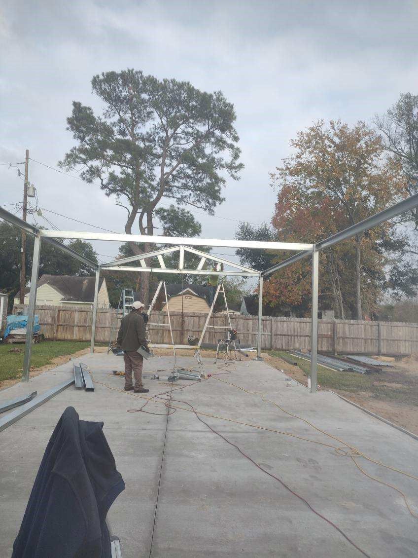 A man is standing in front of a building under construction.