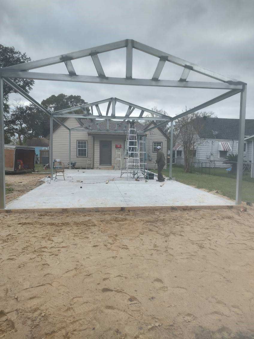 A metal structure is being built in front of a house.