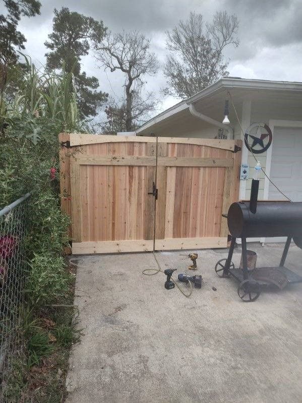 A wooden gate is being built in front of a house.