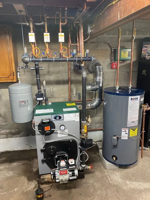 A heating system with a water heater, boiler, pipes, and expansion tank in a basement.