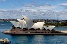 The sydney opera house is floating on top of a body of water.