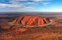 An aerial view of a large rock formation in the middle of a desert