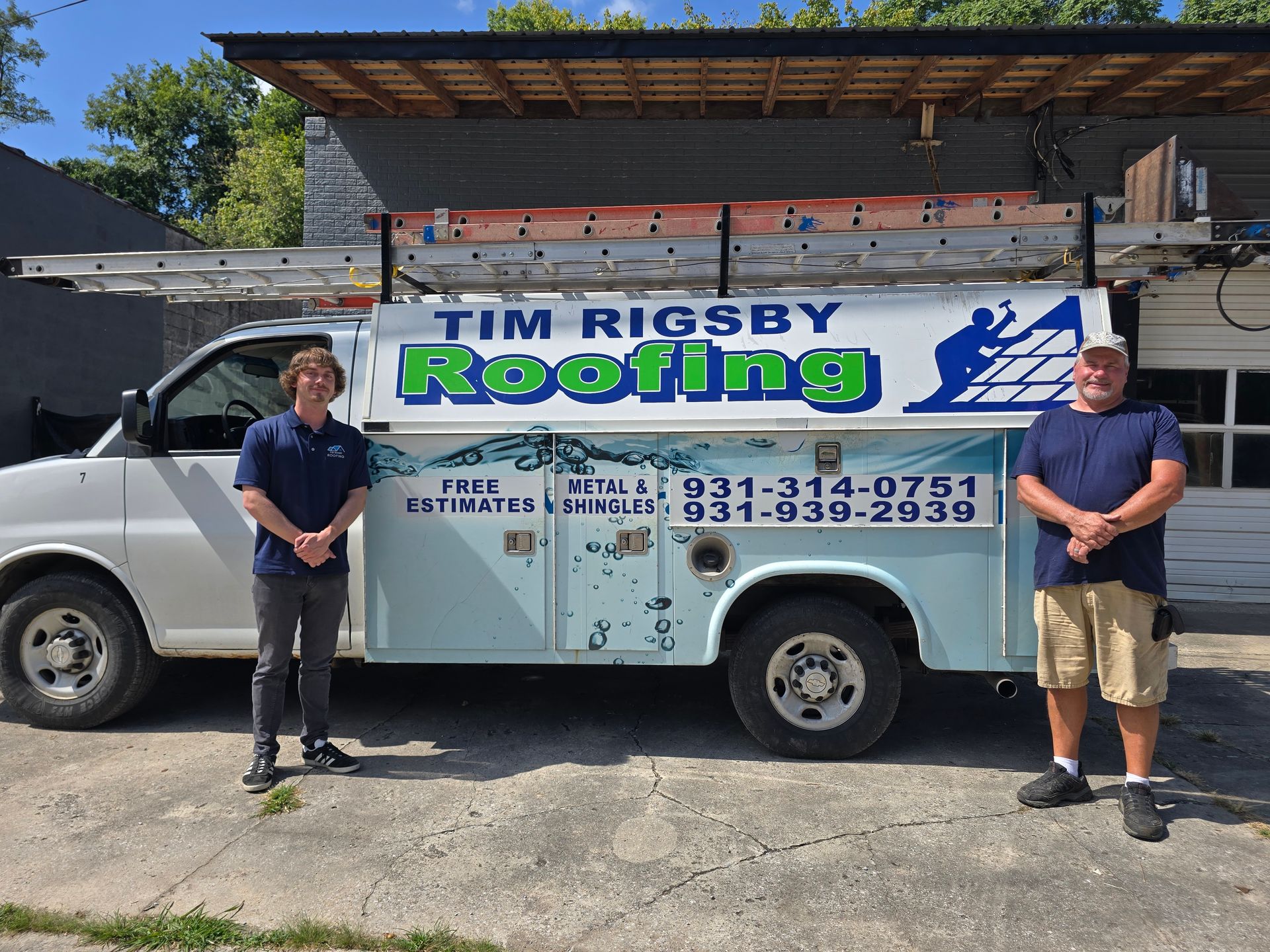 Mr. Rigby Roofing truck parked outside, with two workers standing beside it.