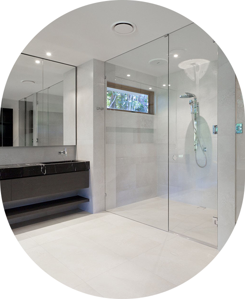 A bathroom with a walk-in shower with beautiful glass doors