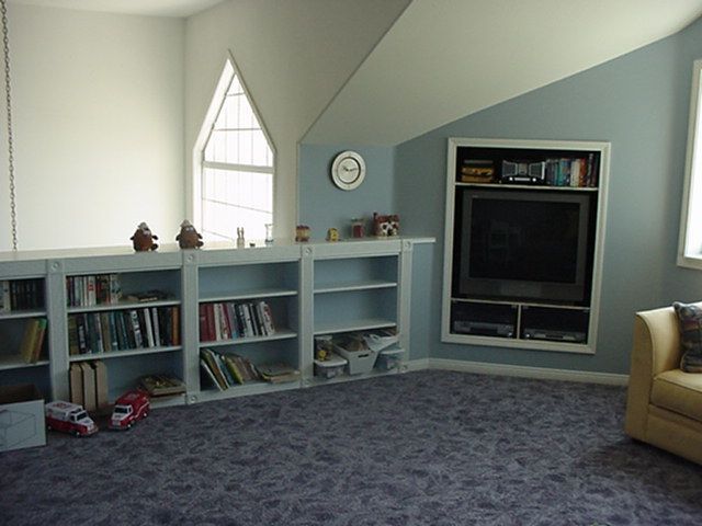 A living room with bookshelves and a flat screen tv