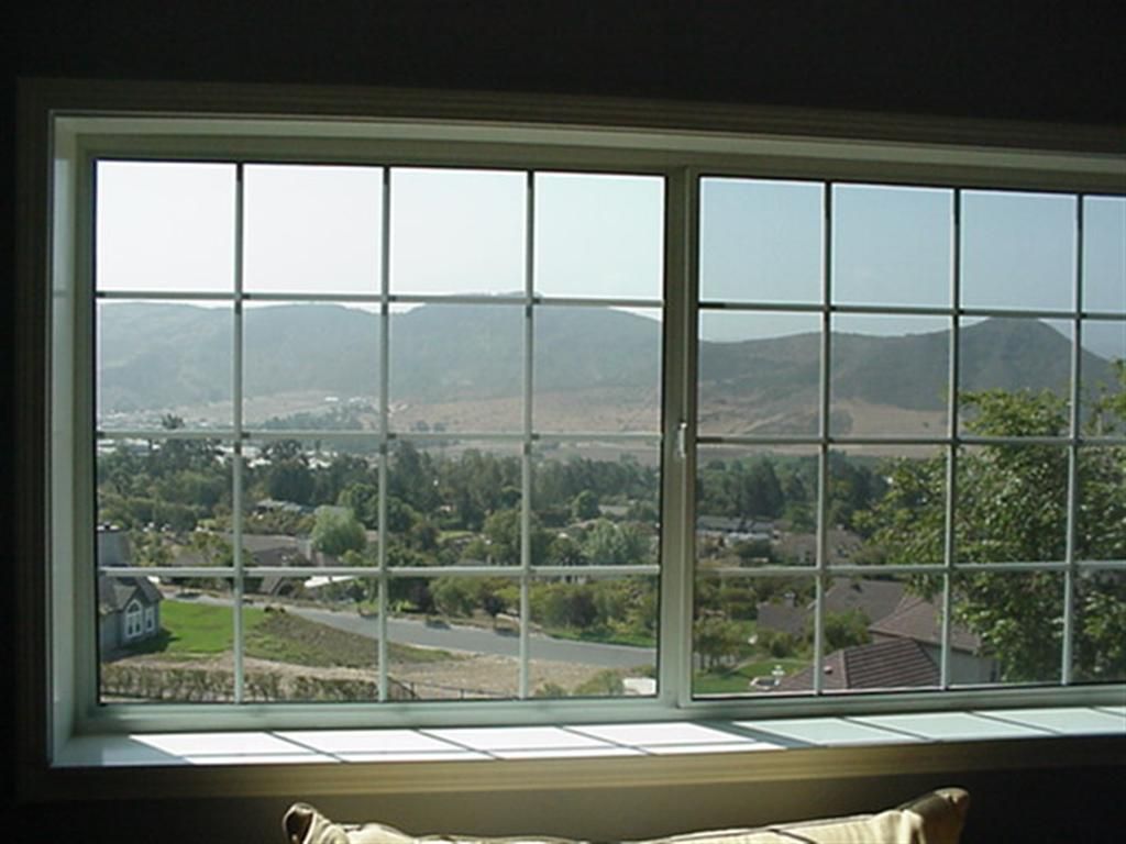 A window with a view of a city and mountains