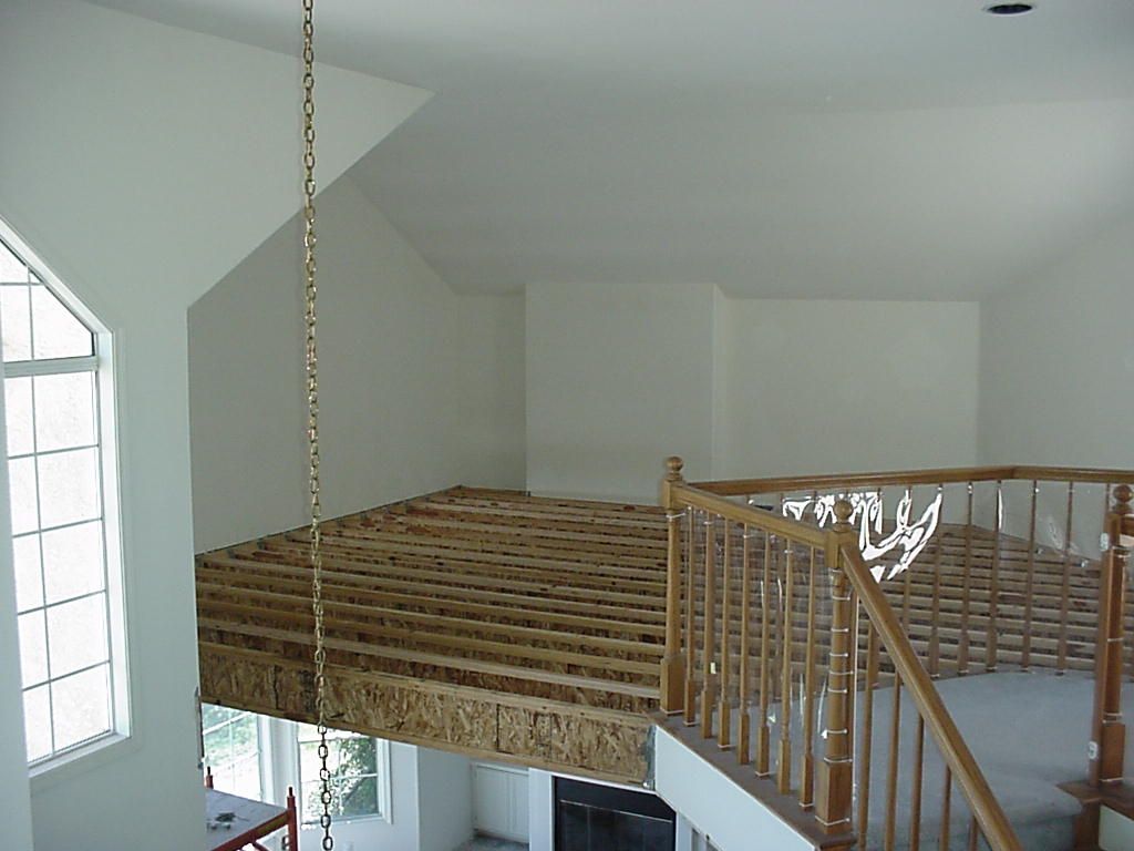 A room with a staircase going up to the second floor