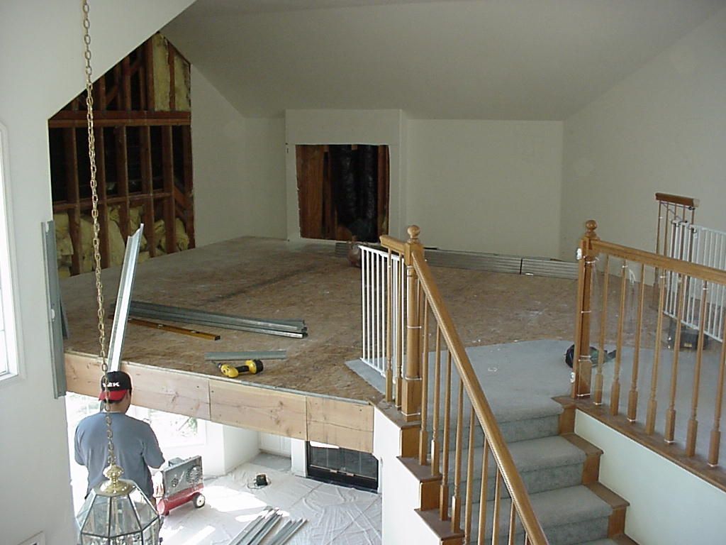 A man is working on a staircase in a house