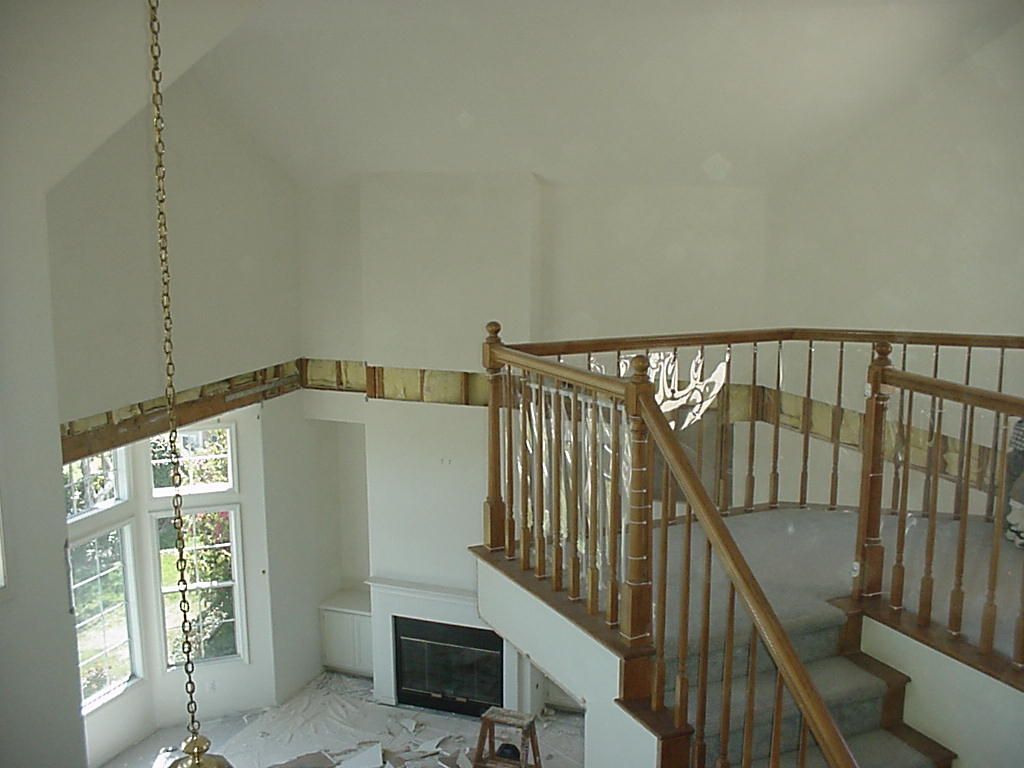 An empty room with stairs and a fireplace in it