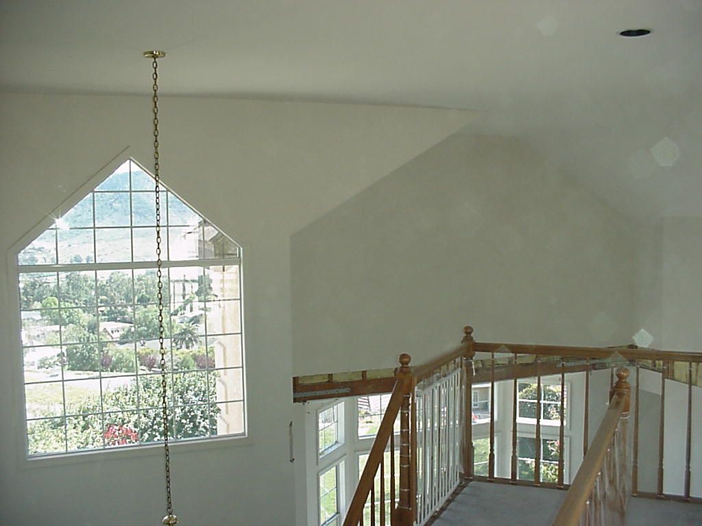 A room with a staircase and a large window