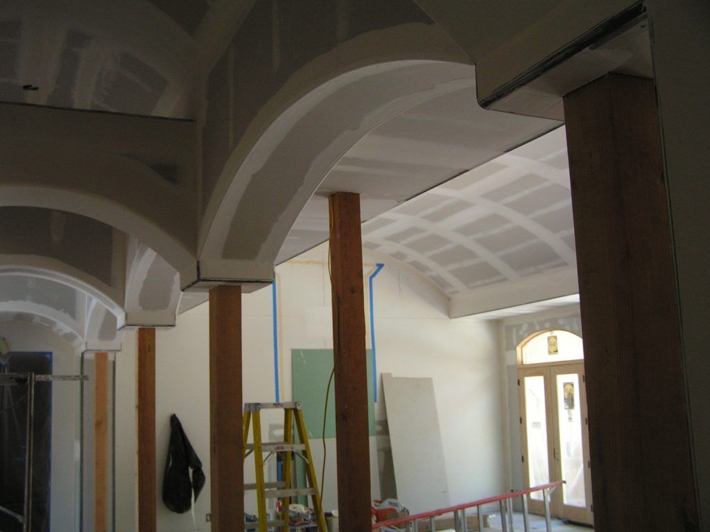 A ladder is in the middle of a room under construction