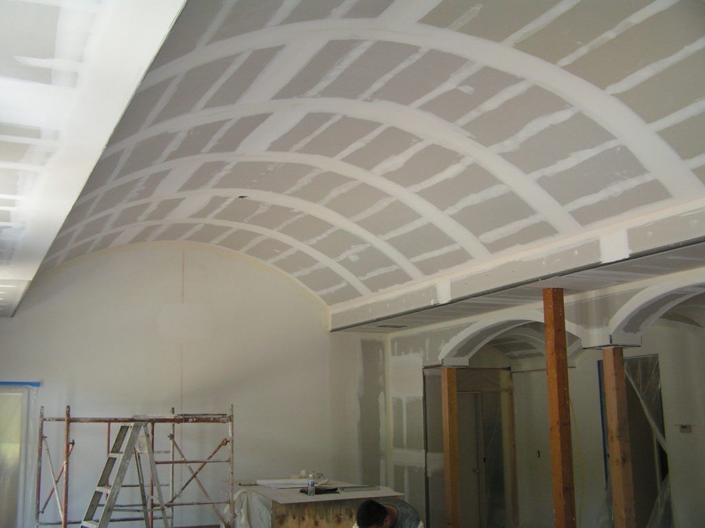 A room with a curved ceiling and a ladder