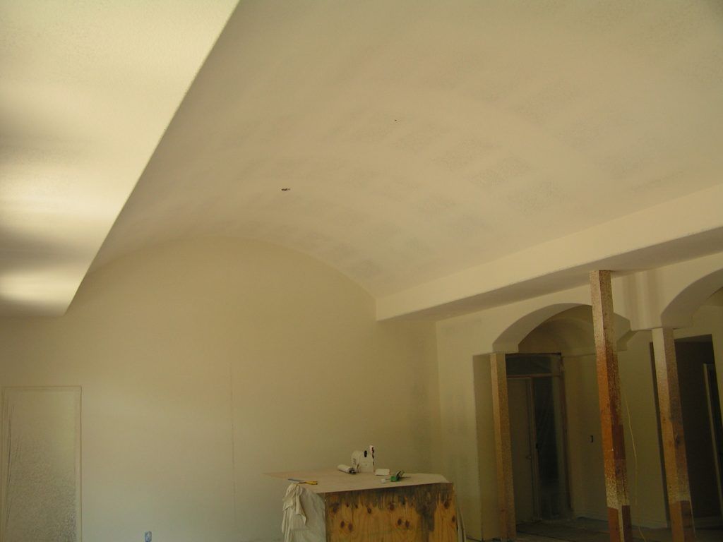 A room with white walls and a wooden table in it.
