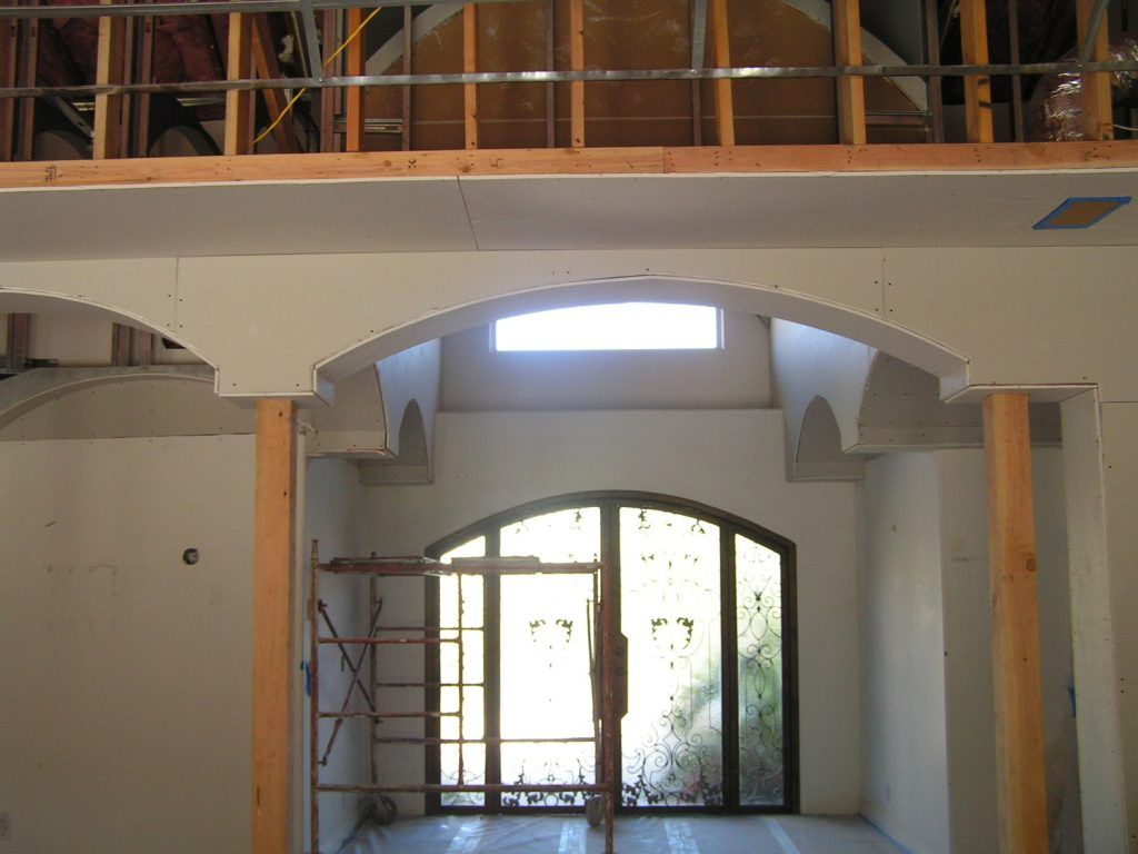 The inside of a building under construction with arched windows