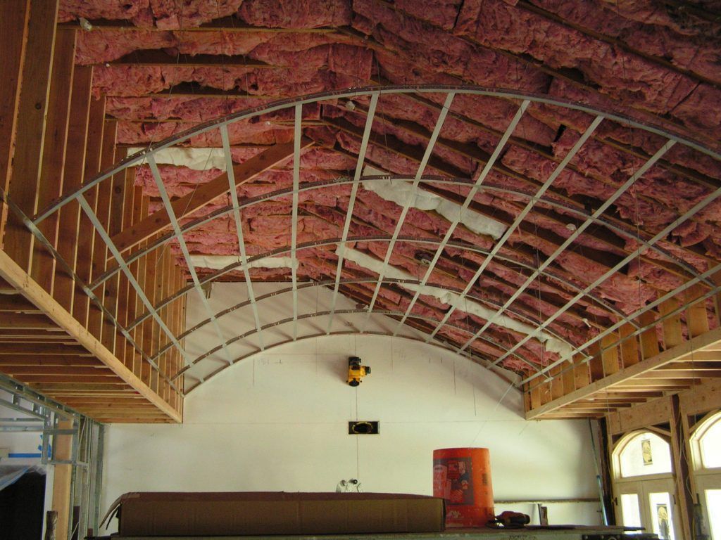 A room with a ceiling that is being built with insulation on it.