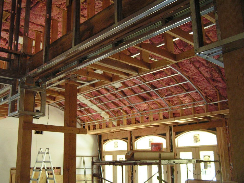 A building under construction with a ladder in the middle